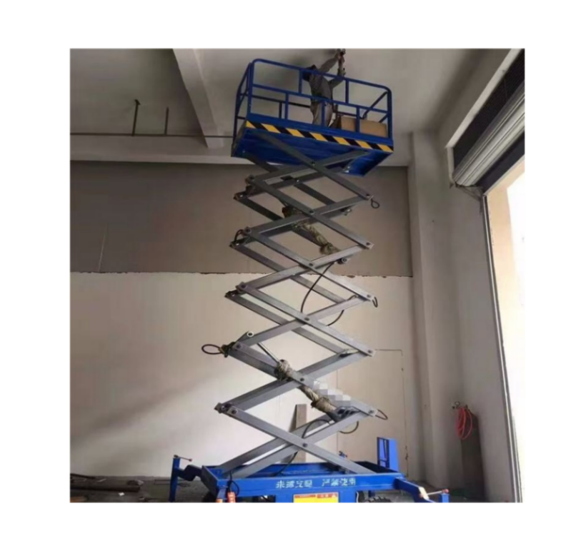 a man standing on a towable scissor lift painting in the Construction site